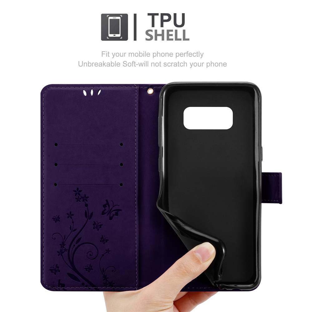 Un telefono dentro una custodia viola con un design floreale, mano che tiene la cover del telefono.