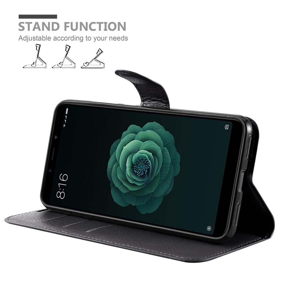 Schwarze Handyhülle mit Telefon. Standfunktion ermöglicht einstellbare Positionen. Telefon zeigt grünes Blumenbild.