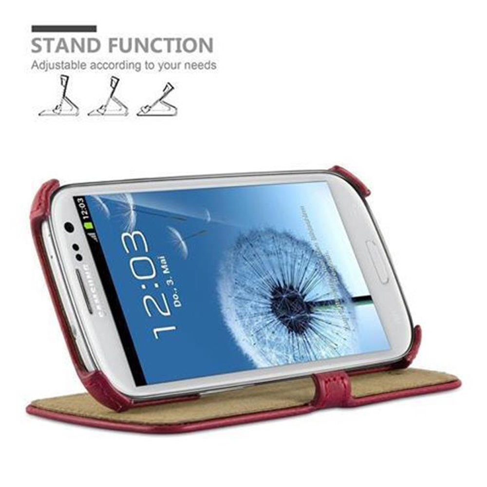 Telefono bianco con schermo a dente di leone. È in una custodia rossa, con funzione stand.