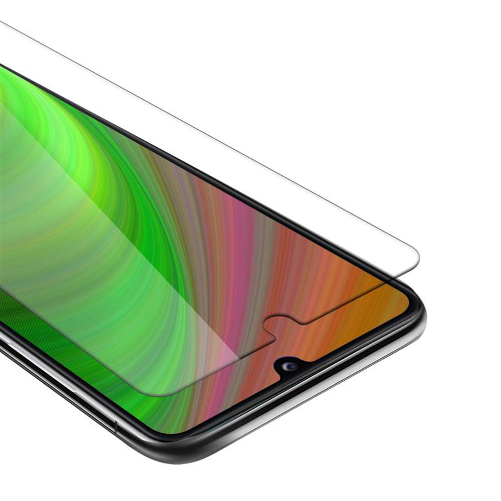 Smartphone con protezione schermo, sfondo verde, rosa e giallo. La protezione è leggermente sopra lo schermo.