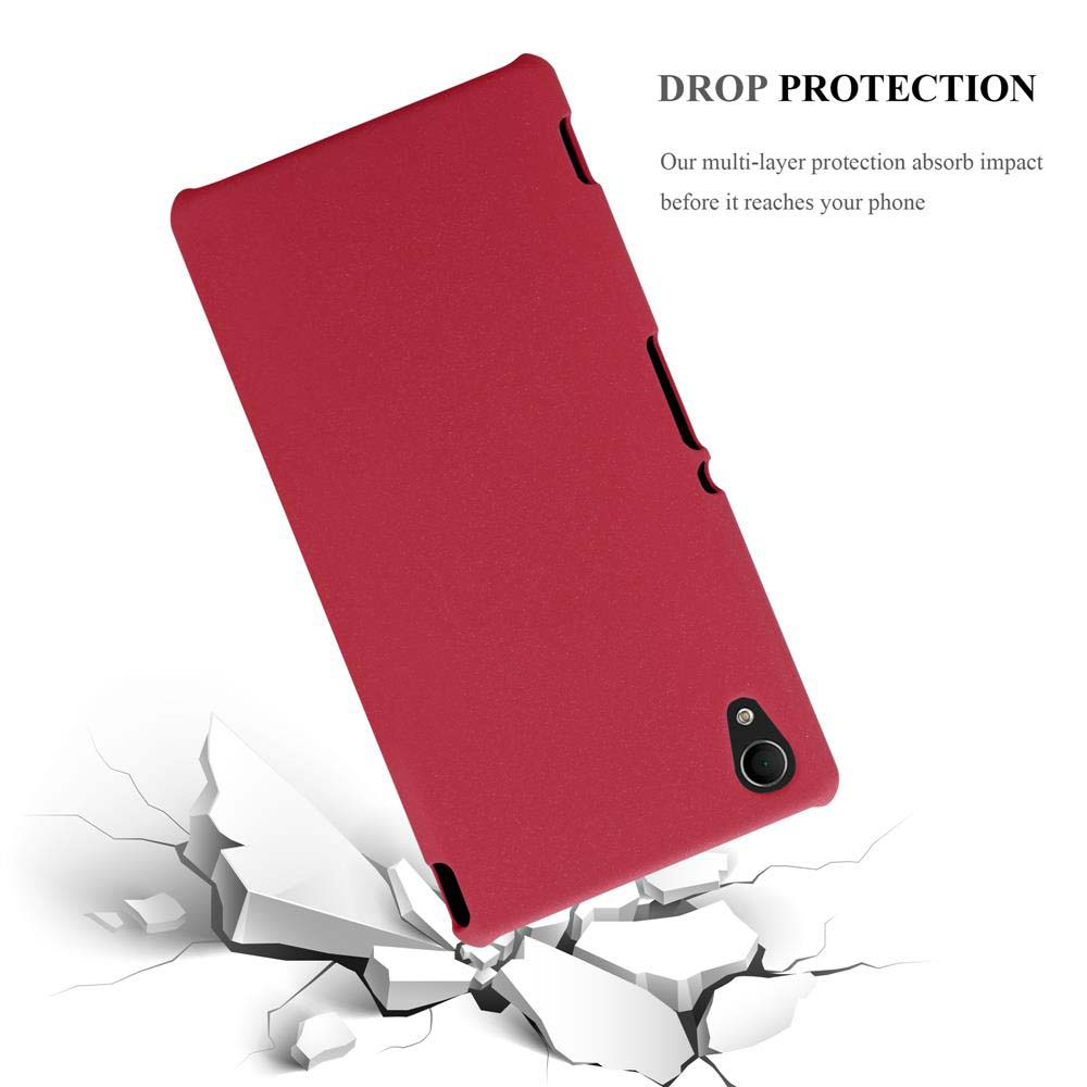 Funda roja para teléfono sobre fondo blanco, rompiendo una superficie blanca.