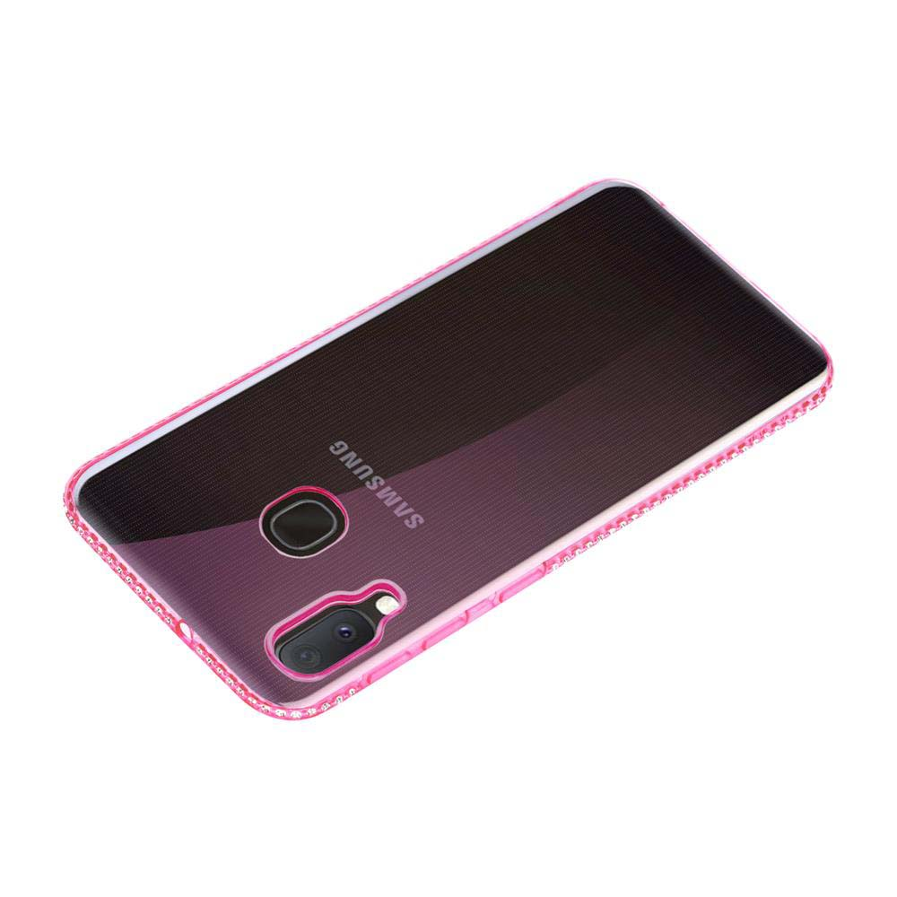 Custodia rosa per telefono. La custodia ha un bordo rosa con piccole pietre. Il telefono ha una fotocamera e un flash.