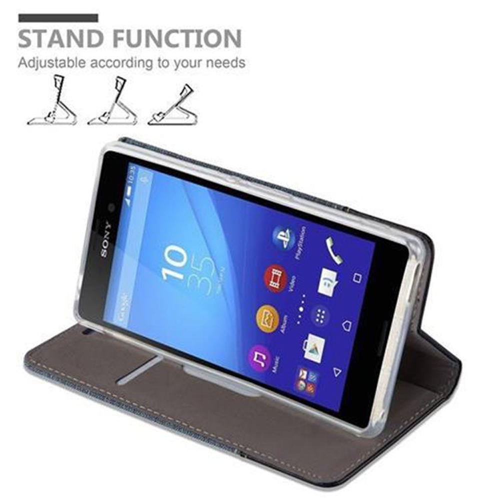 Funda de teléfono con teléfono dentro, de pie. Colores gris y negro. Función de soporte ajustable.