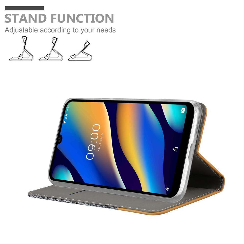 Telefono in custodia aperta, schermo del telefono con testo: 'STAND FUNCTION'.