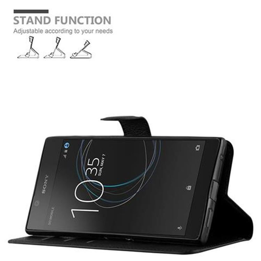 Schwarzes Telefon in schwarzem Gehäuse, Standfunktion. Text und Symbole oben sichtbar.
