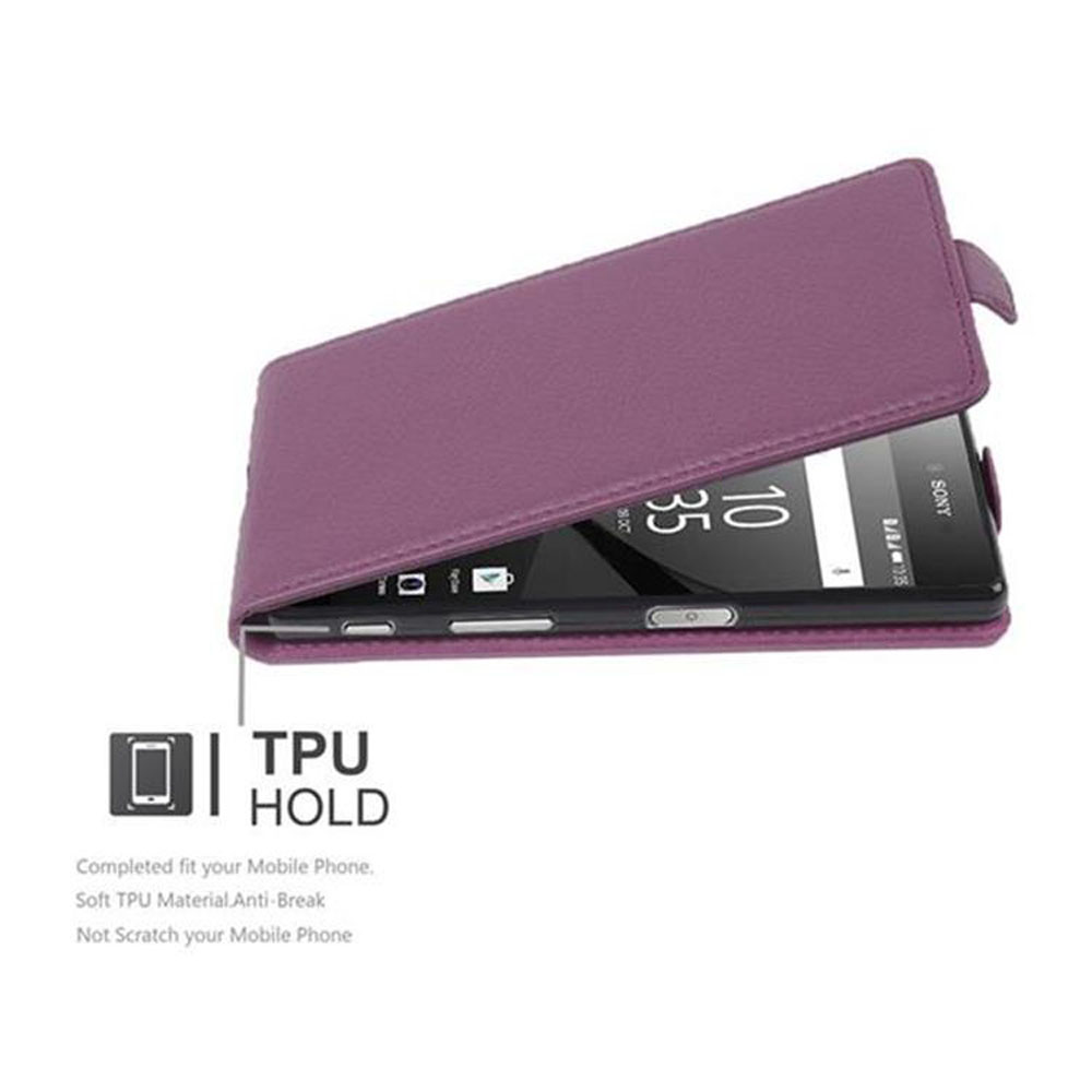Un teléfono negro en una funda morada. Se anuncia TPU HOLD.