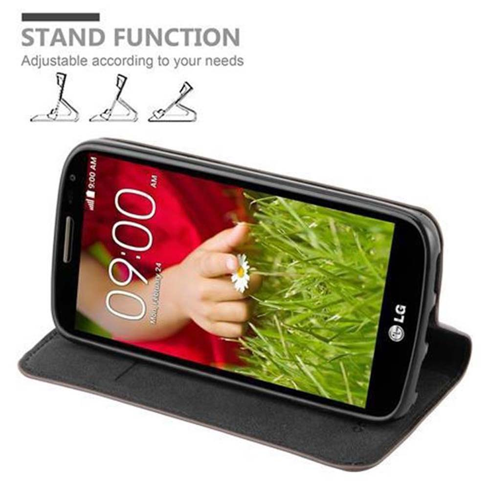Telefon in einer Hülle auf einem Ständer, zeigt eine Hand, die eine Blume auf dem Bildschirm hält.