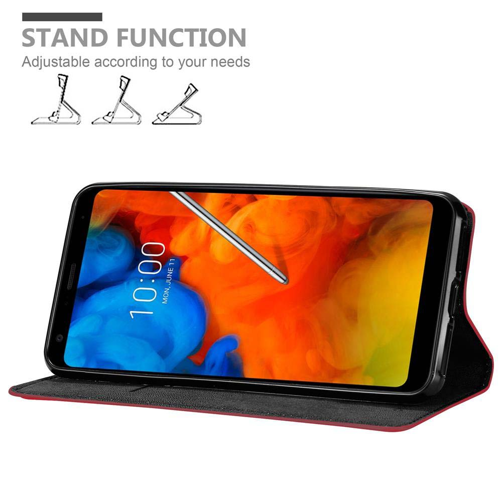 Ein Telefon mit Ständer. Das Telefon zeigt die Uhrzeit. Die Hülle ist rot und das Telefon ist schwarz.