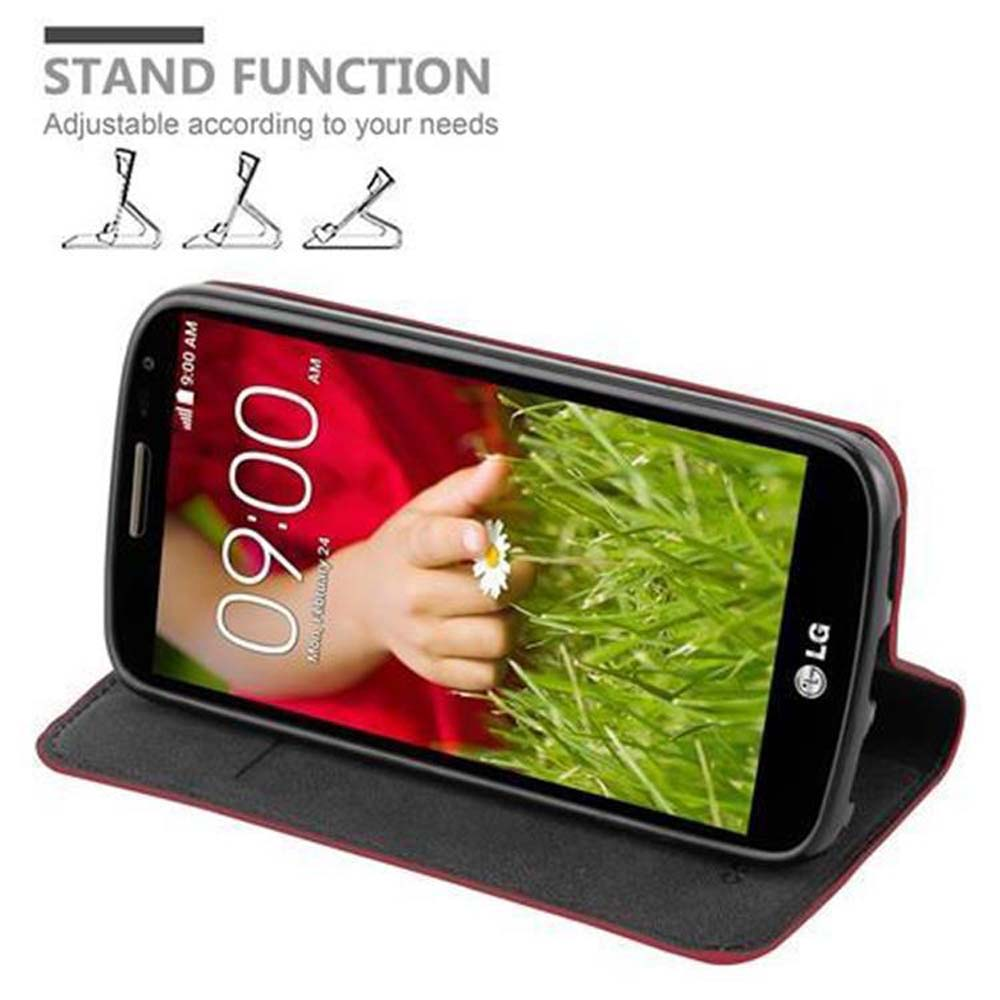 Telefon in Hülle, aufgestellt. Anzeige zeigt eine Hand, die eine Gänseblümchen hält. Text: STANDFUNKTION.