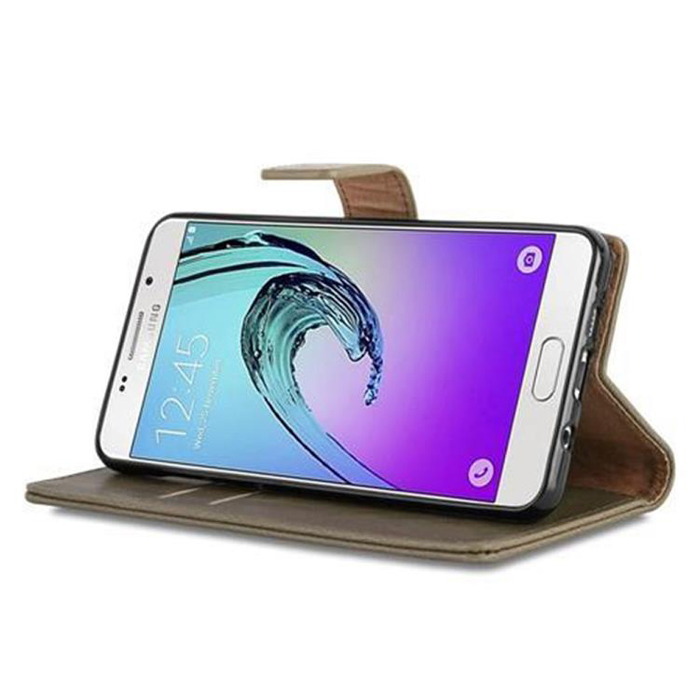Un teléfono en una funda marrón, abierto. El teléfono muestra una interfaz azul y blanca. La funda está sobre una mesa.