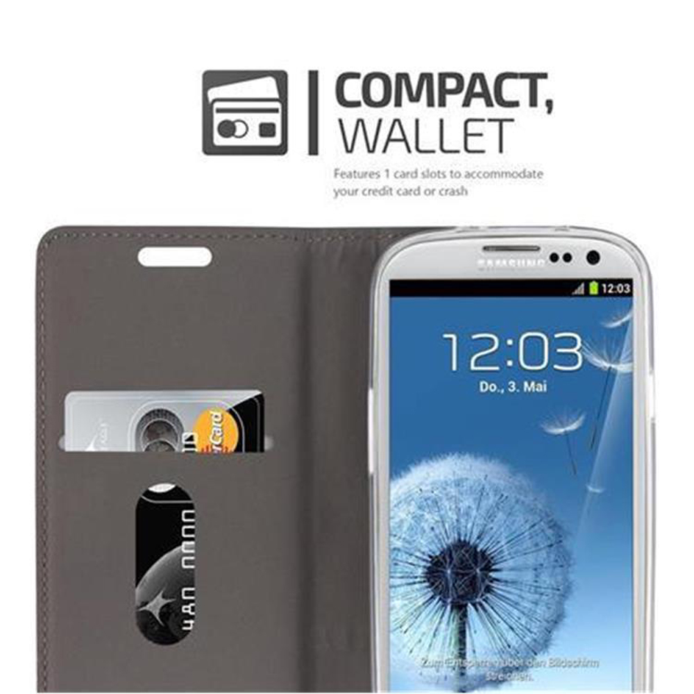 Telefono con custodia grigia che mostra un orologio digitale. C'è uno slot per carta di credito.