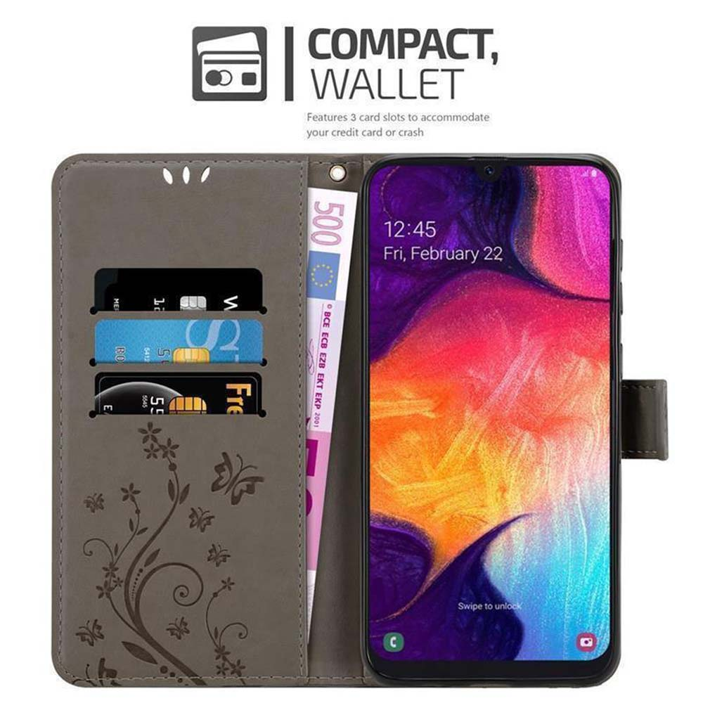 Custodia per telefono con carte di credito e denaro. Il telefono mostra uno schermo. Design grigio, marrone e floreale.