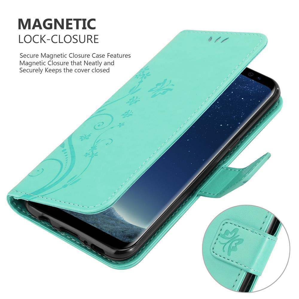 Una custodia per telefono turchese con un lembo aperto e un telefono all'interno, che mostra un design floreale e una chiusura magnetica.