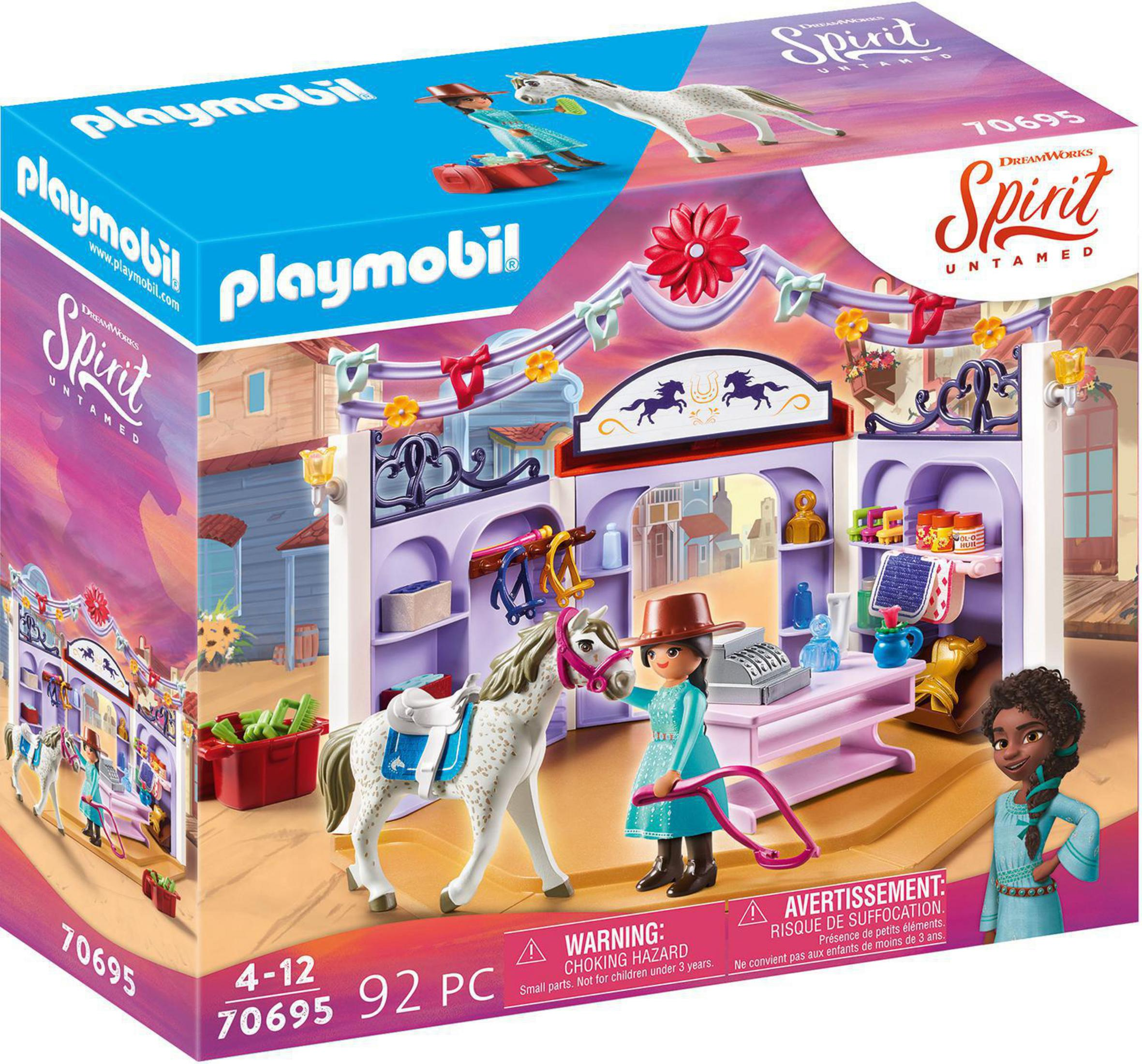 Set de juguetes Playmobil con caballos y figuras en un entorno de tienda del oeste. Imágenes en la caja.