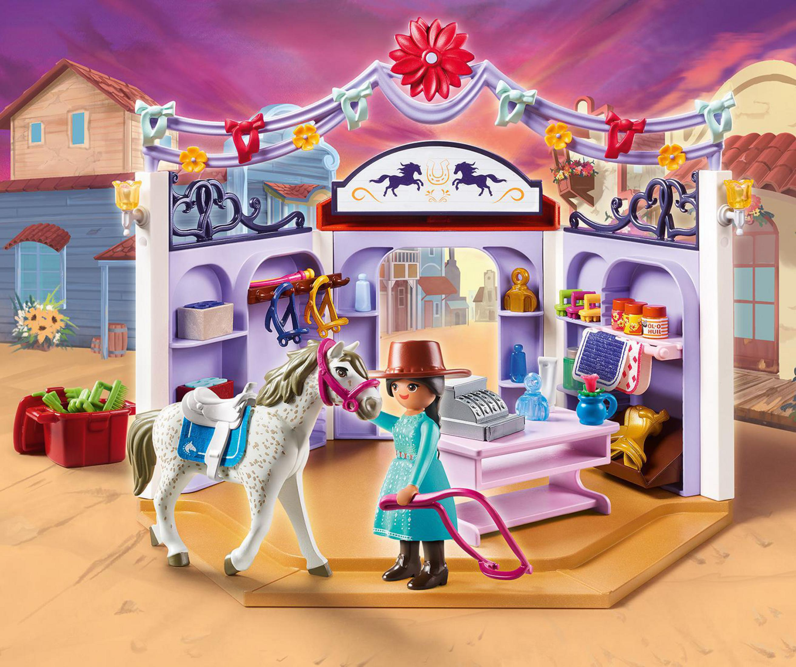 Set de establo Playmobil con un caballo, una niña y accesorios de tienda.
