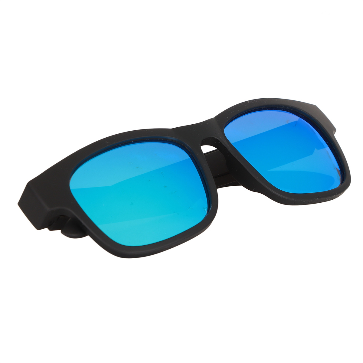 Schwarze Sonnenbrille mit blauen Gläsern, leicht angewinkelt. Die Brille liegt auf einer weißen Oberfläche.