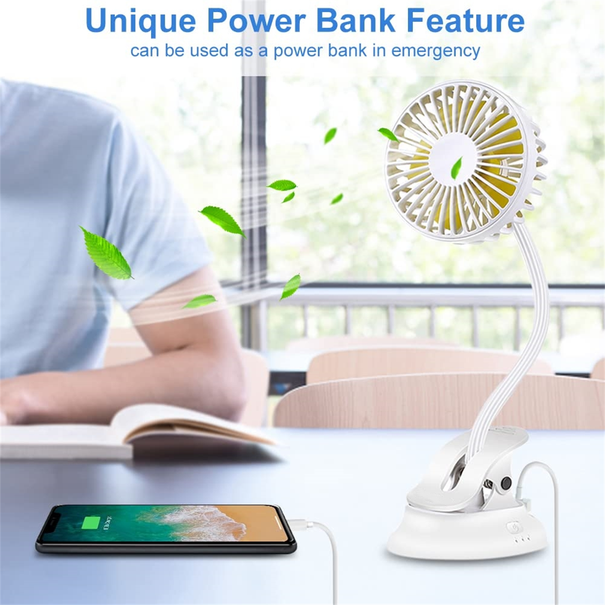 Ein Telefon, das von einem weißen Ventilator aufgeladen wird. Text: Einzigartige Powerbank-Funktion. Blätter um den Ventilator herum.