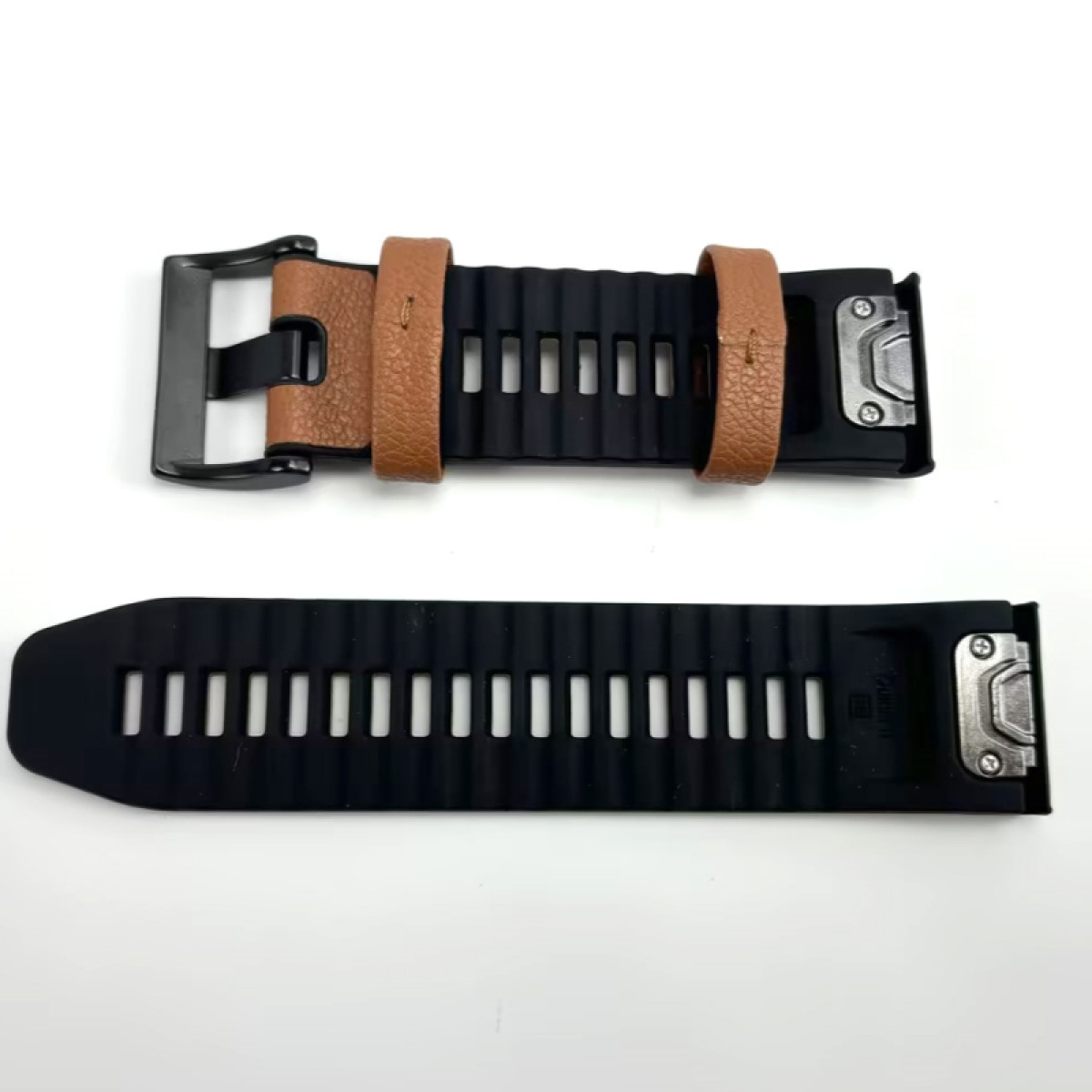 Czarny i brązowy pasek do zegarka z klamrą. Pasek wykonany jest ze skóry i karbowanej gumy.