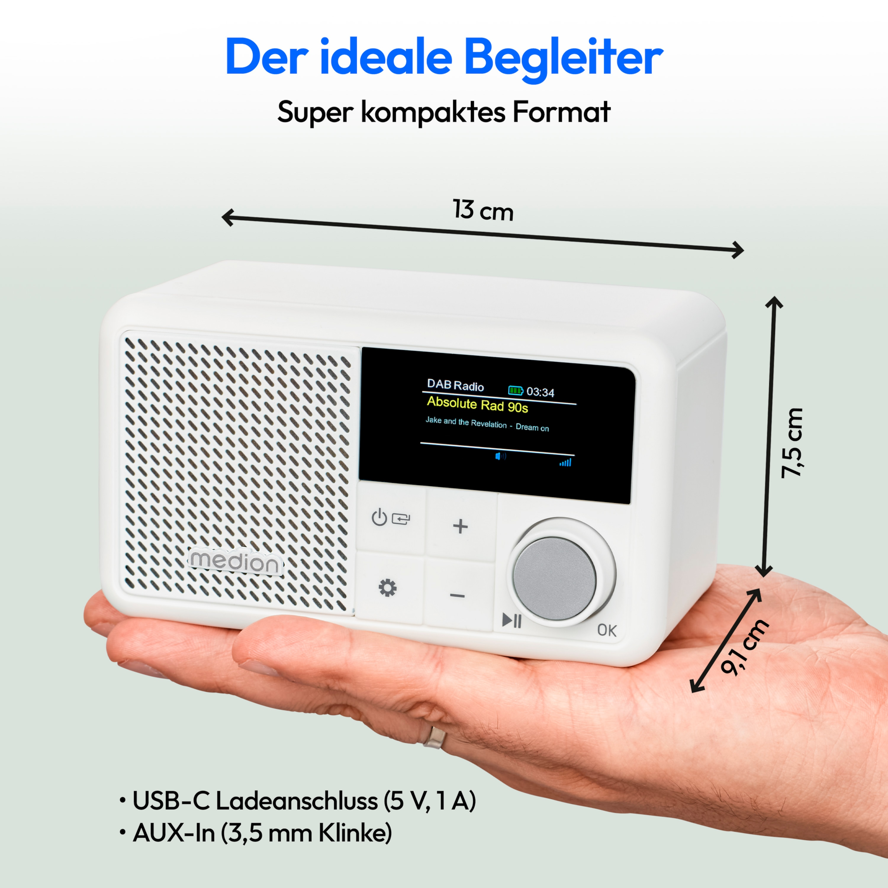 A person's hand holding a white radio with dimensions and features.