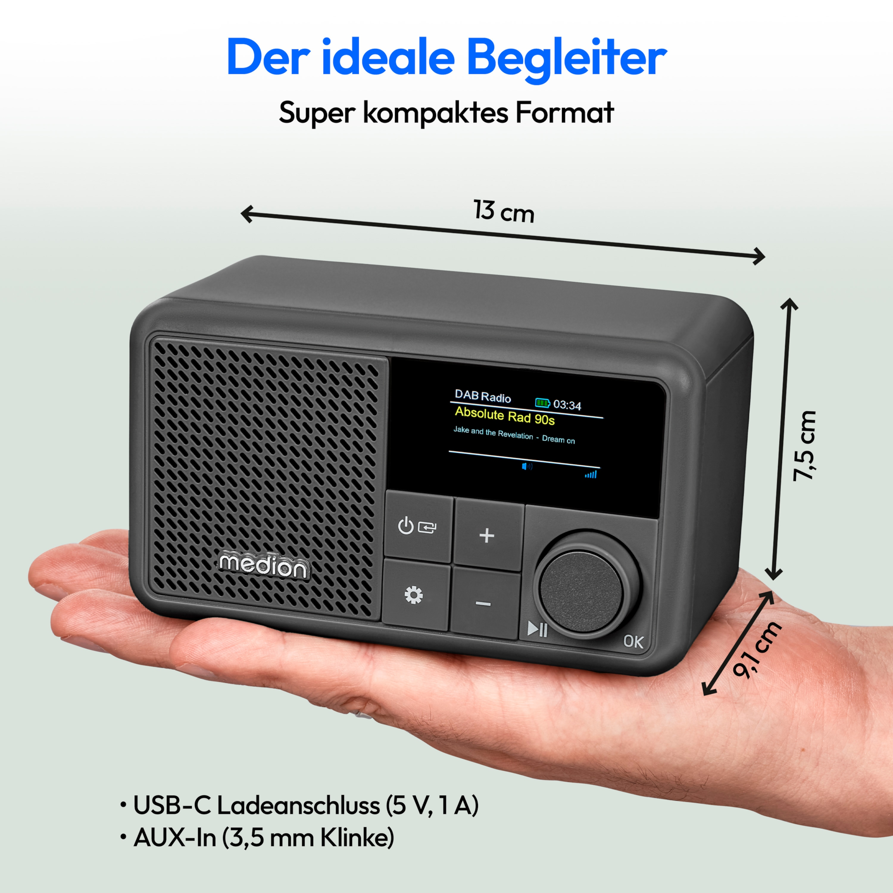A person's hand holding a gray radio with dimensions and features.