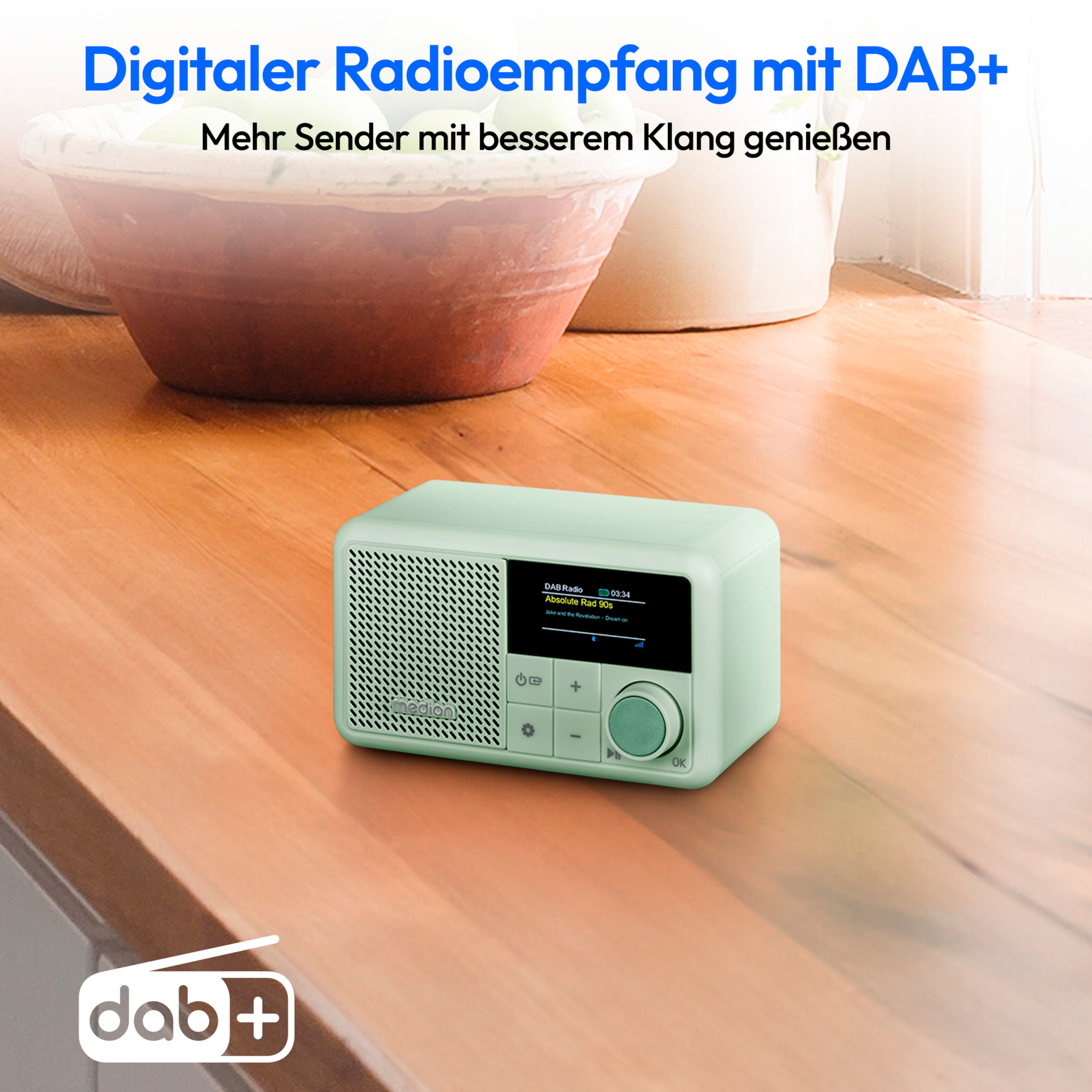 Mint green radio on wooden table. Text says: Digitaler Radioempfang mit DAB+. Dab+ logo at the bottom.