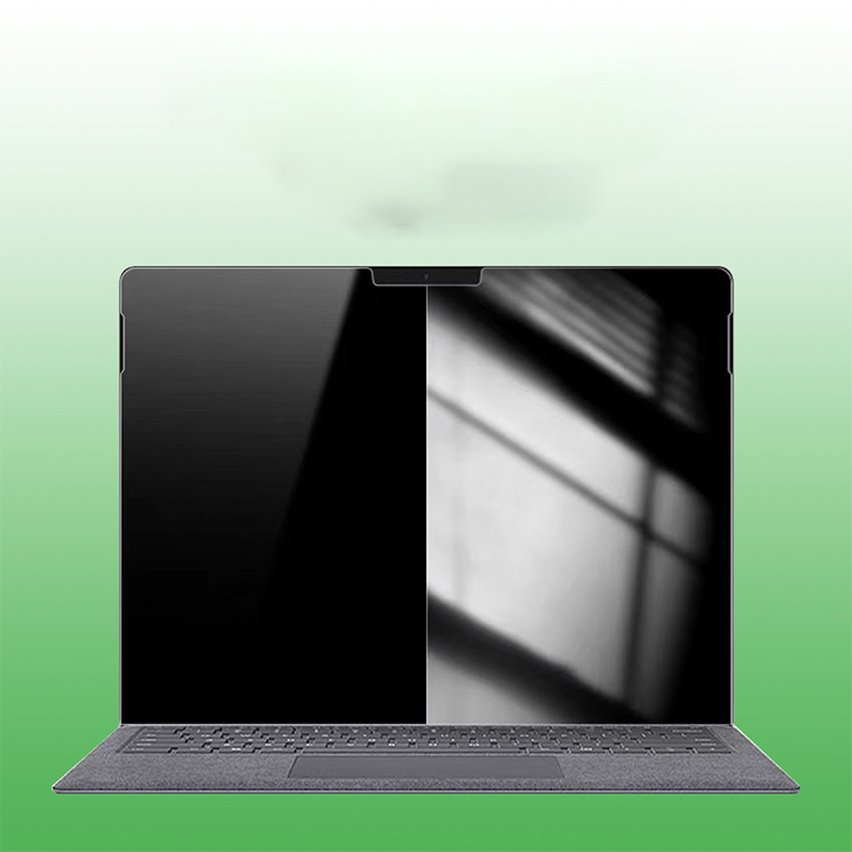 Un laptop con protezione schermo installata. È grigio, con sfondo verde e bianco.