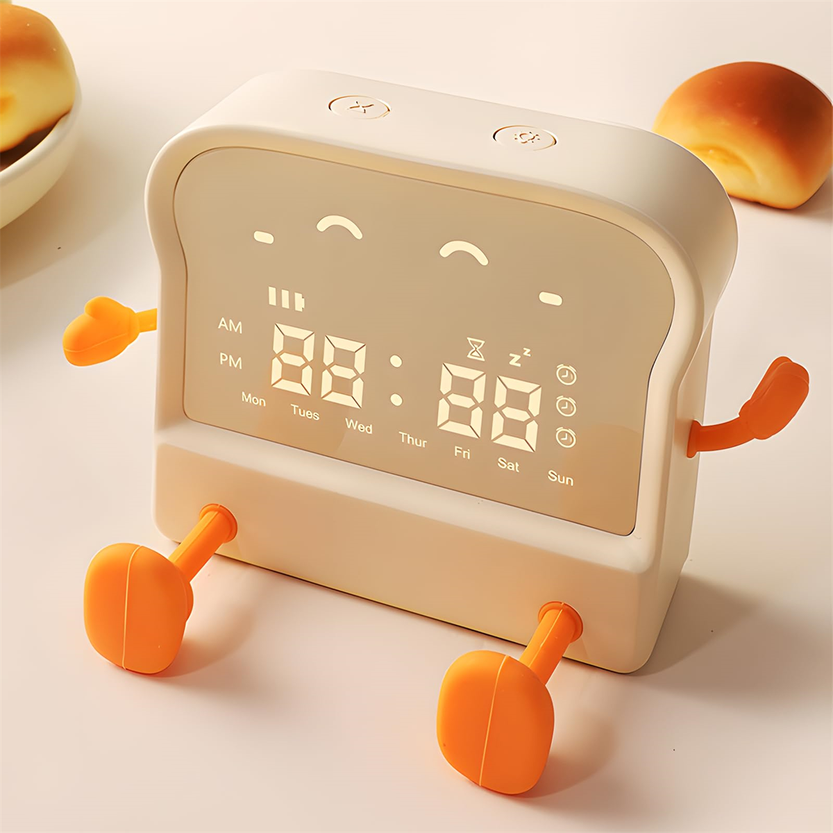 Eine Uhr in Toastform mit digitaler Anzeige und orangefarbenen Füßen.