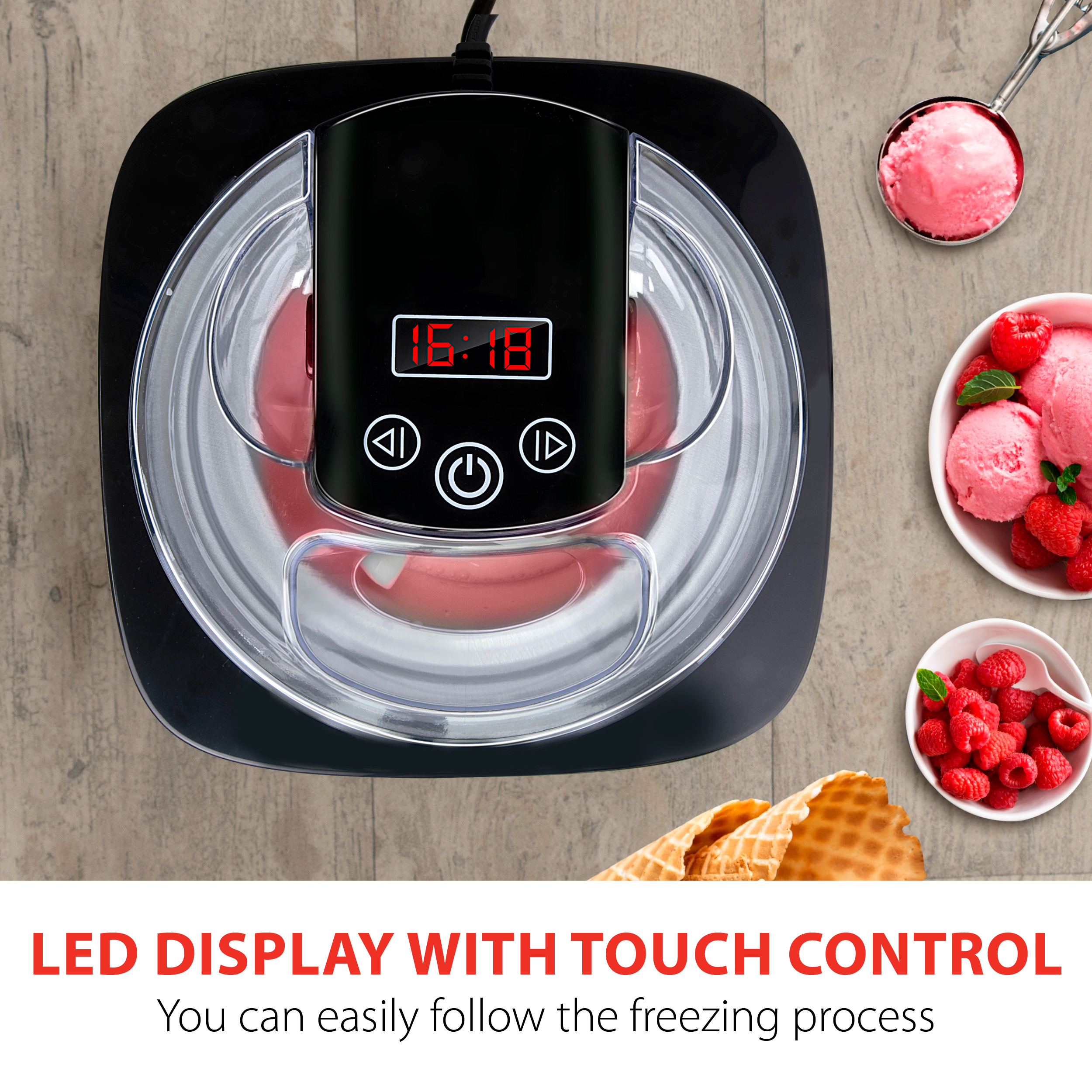 Ice cream maker with digital display. Ice cream in a bowl, and waffles. Wooden table.