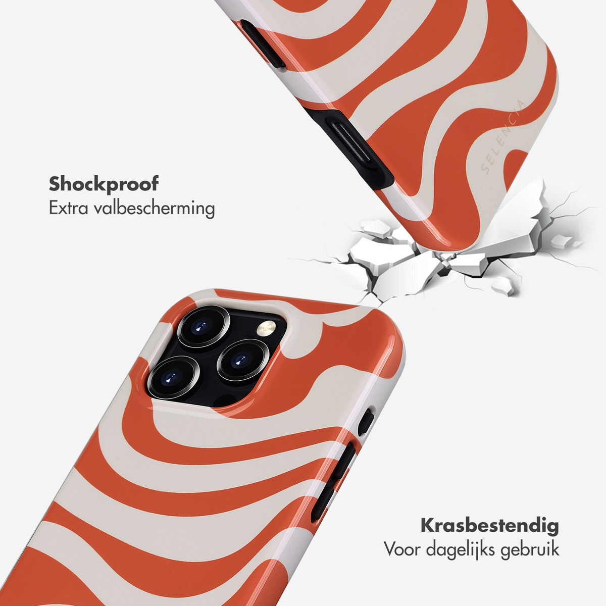 Twee telefoonhoesjes met een oranje en witte golfdesign. Eén is kapot, één ligt op de grond.