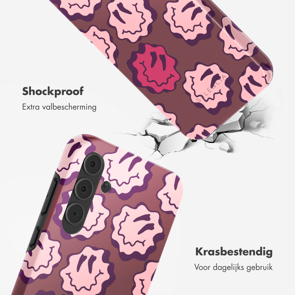 Una custodia per telefono con faccine sorridenti rosa su sfondo marrone. Un telefono è all'interno di una custodia abbinata. Superficie incrinata sullo sfondo.