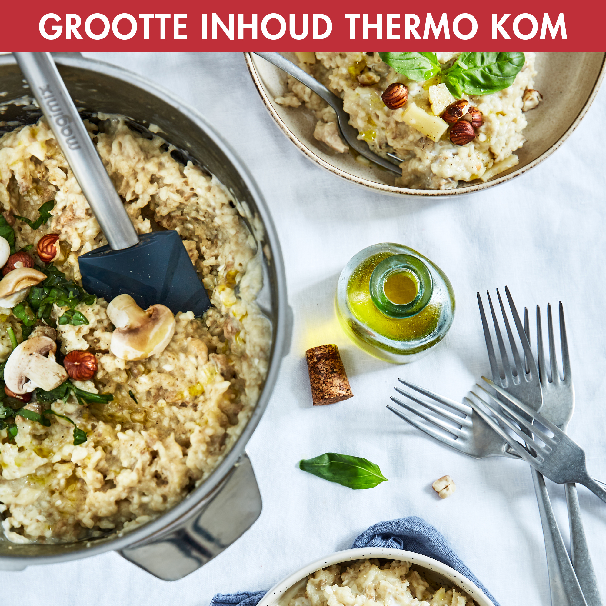 Risotto in a pot and a bowl, with ingredients. White table, basil leaves, forks, olive oil.