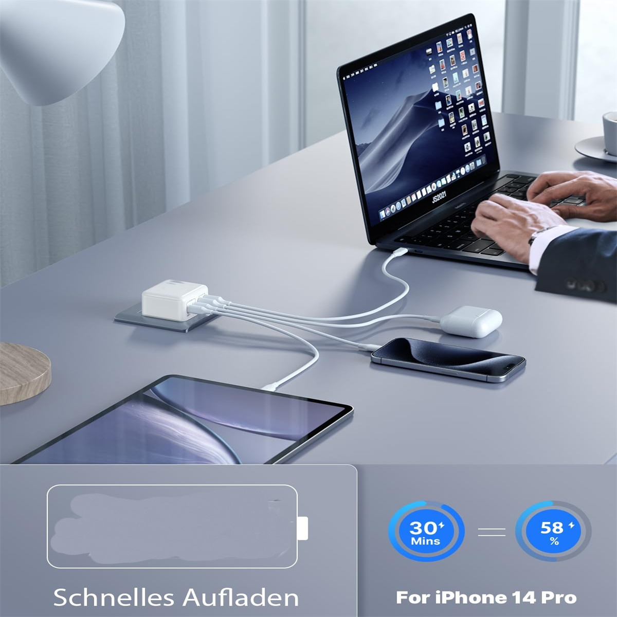 Laptop, Telefon und Tablet werden mit einem Mehrfach-Ladegerät aufgeladen.