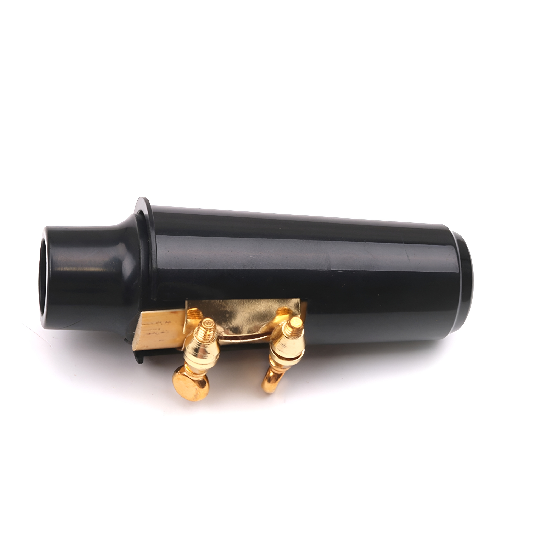 Schwarzer zylindrischer Stecker mit goldfarbenen Anschlüssen auf weißer Oberfläche.