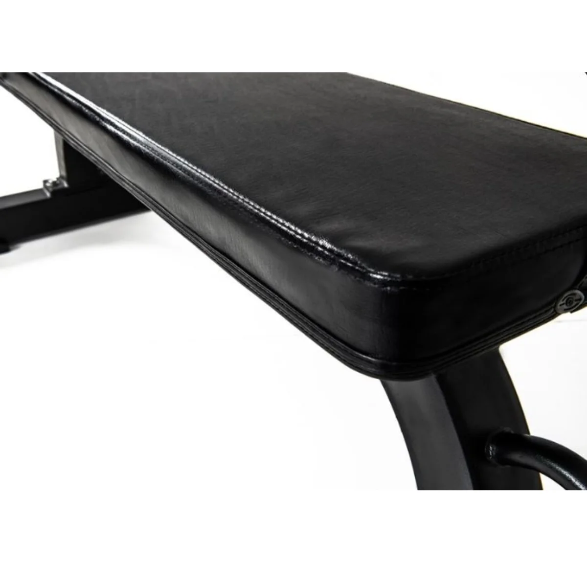 Black gym bench with leather-like surface. Angled view, white background.