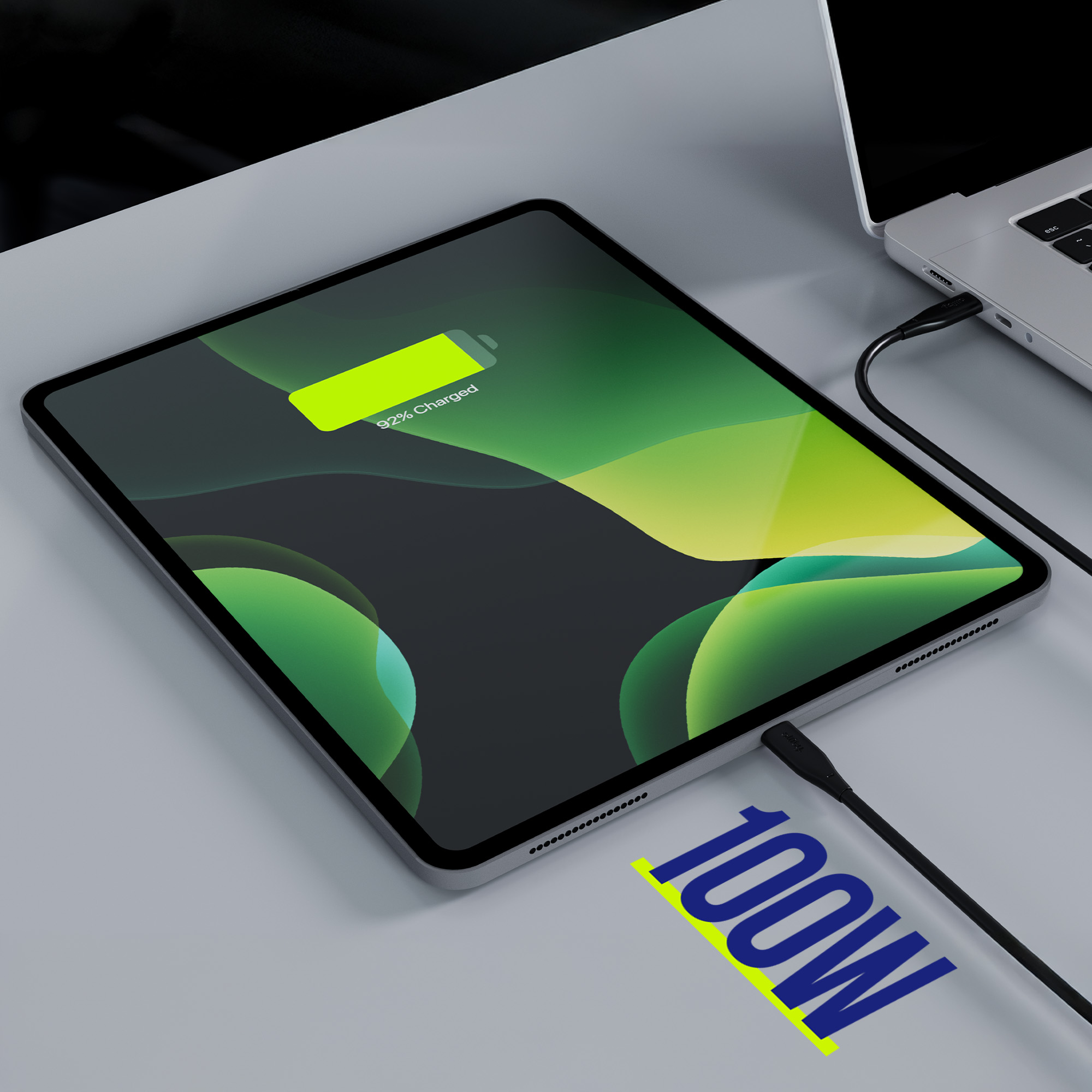 Tablet ładujący się czarnym kablem. Ekran pokazuje wskaźnik ładowania na poziomie 92%.