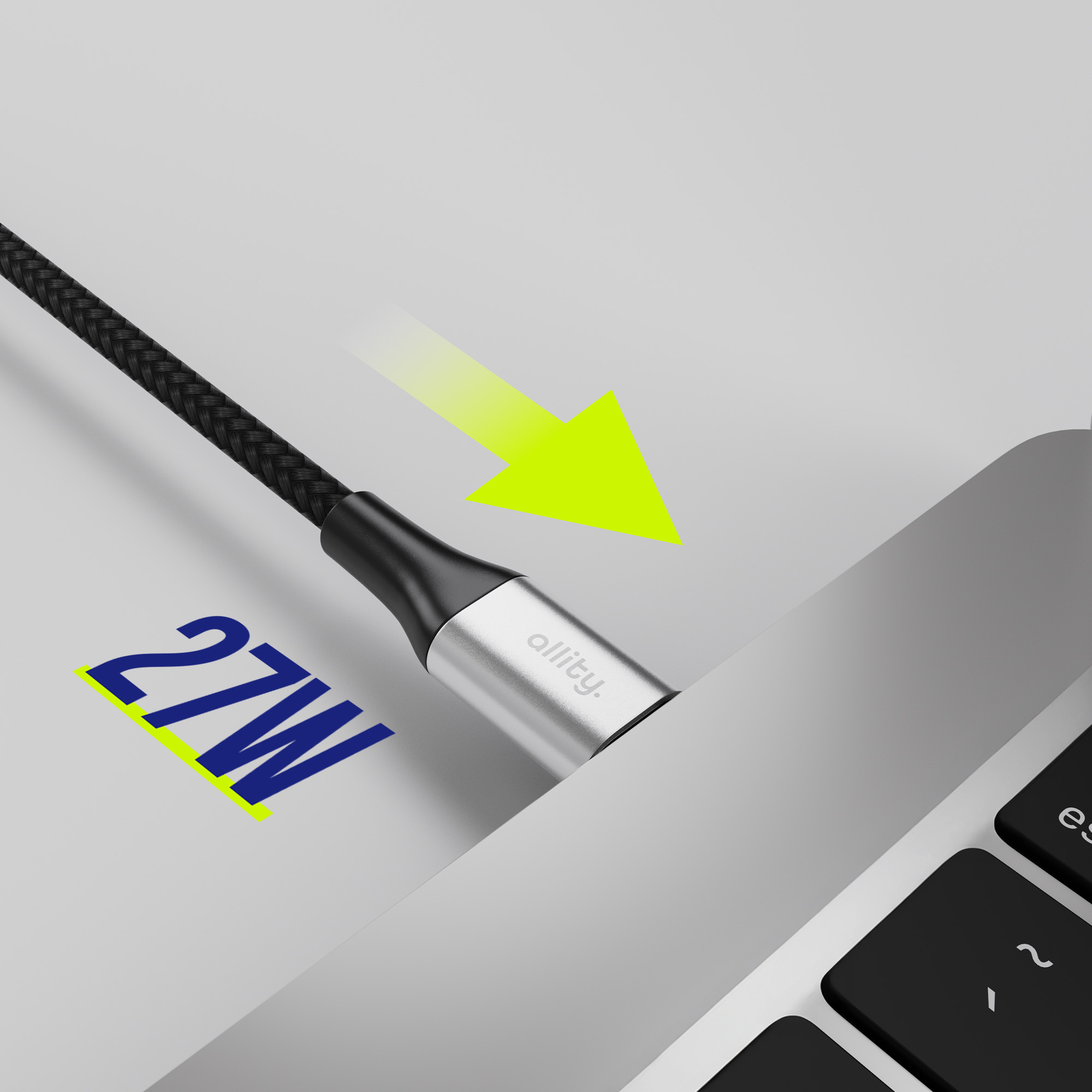 Czarny i srebrny kabel jest podłączany do laptopa. 27W jest wydrukowane na niebiesko po lewej stronie.