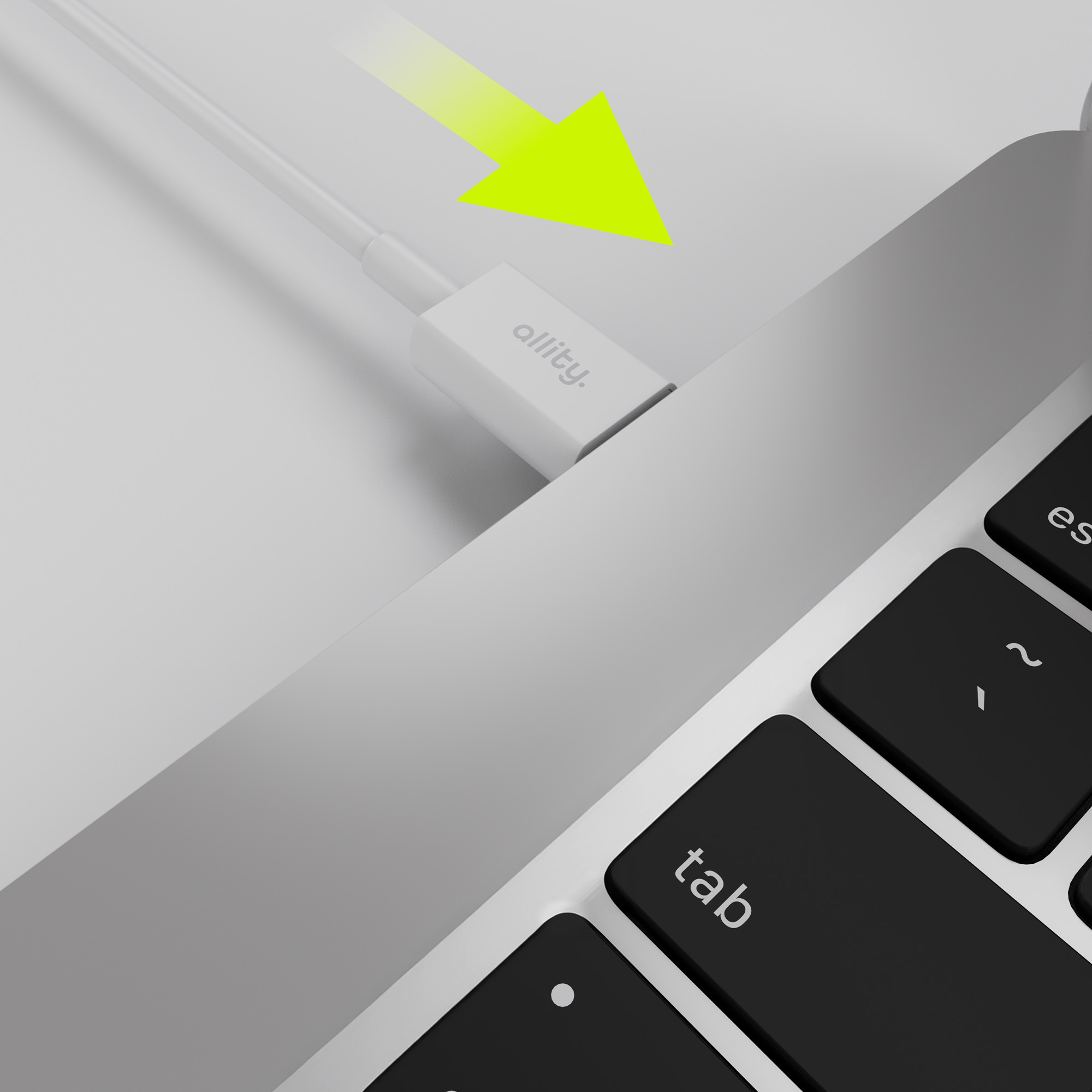 Klawiatura laptopa i biały kabel podłączony do białej przejściówki z napisem 'allity'. Żółta strzałka.