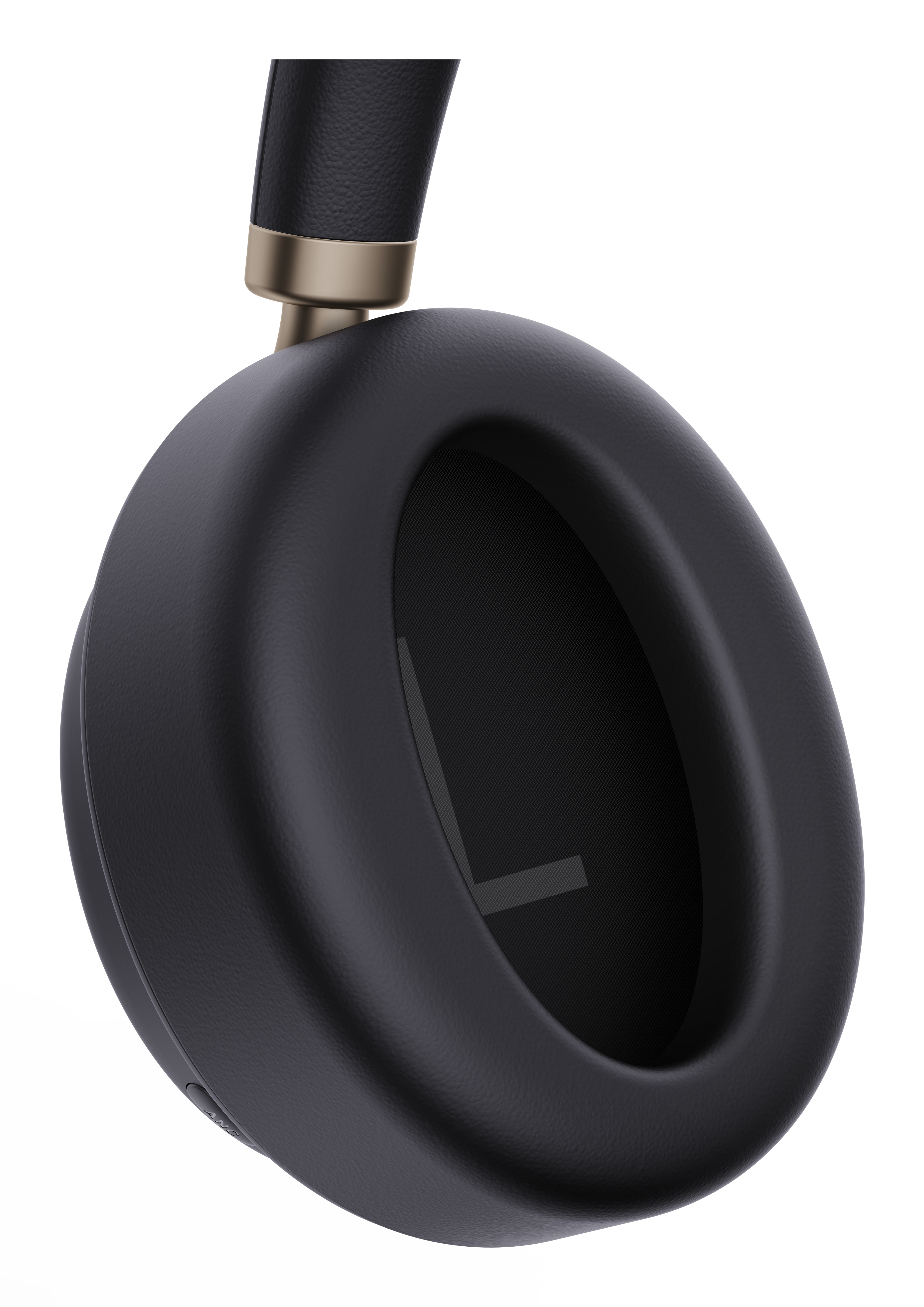 Close-up of a black headphone ear cup with a gold accent on the top.
