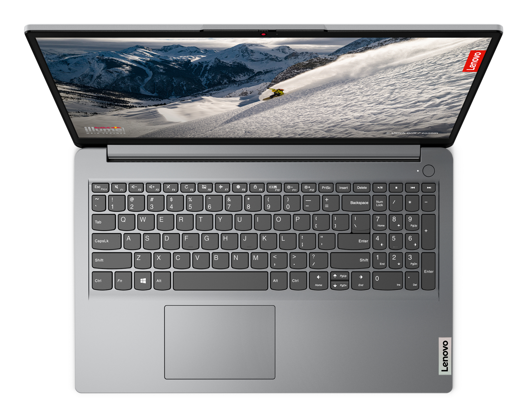 Klawiatura laptopa, otwarta, ze sceną śnieżnej góry na ekranie.