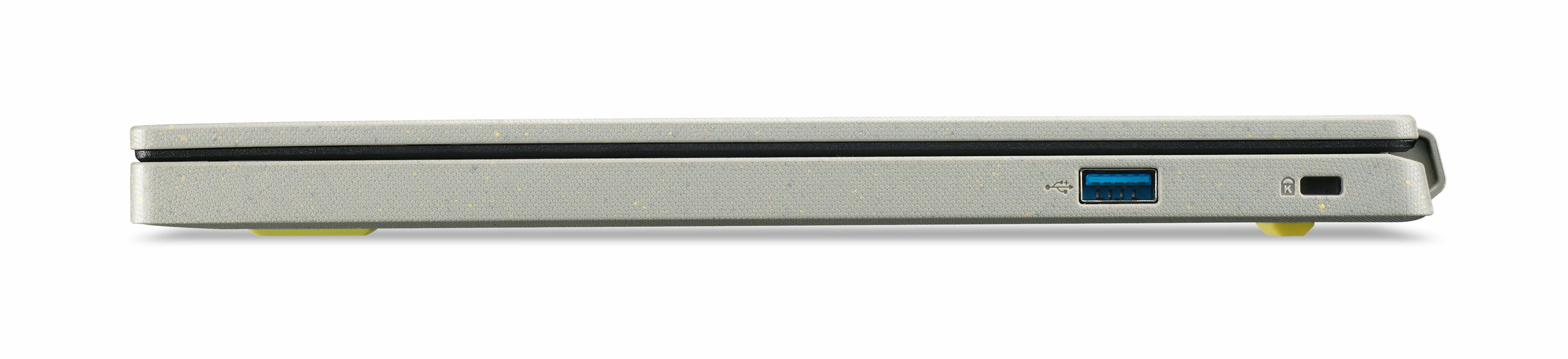 Widok z boku szarego laptopa, z portami USB i portem ładowania, z żółtymi nóżkami.