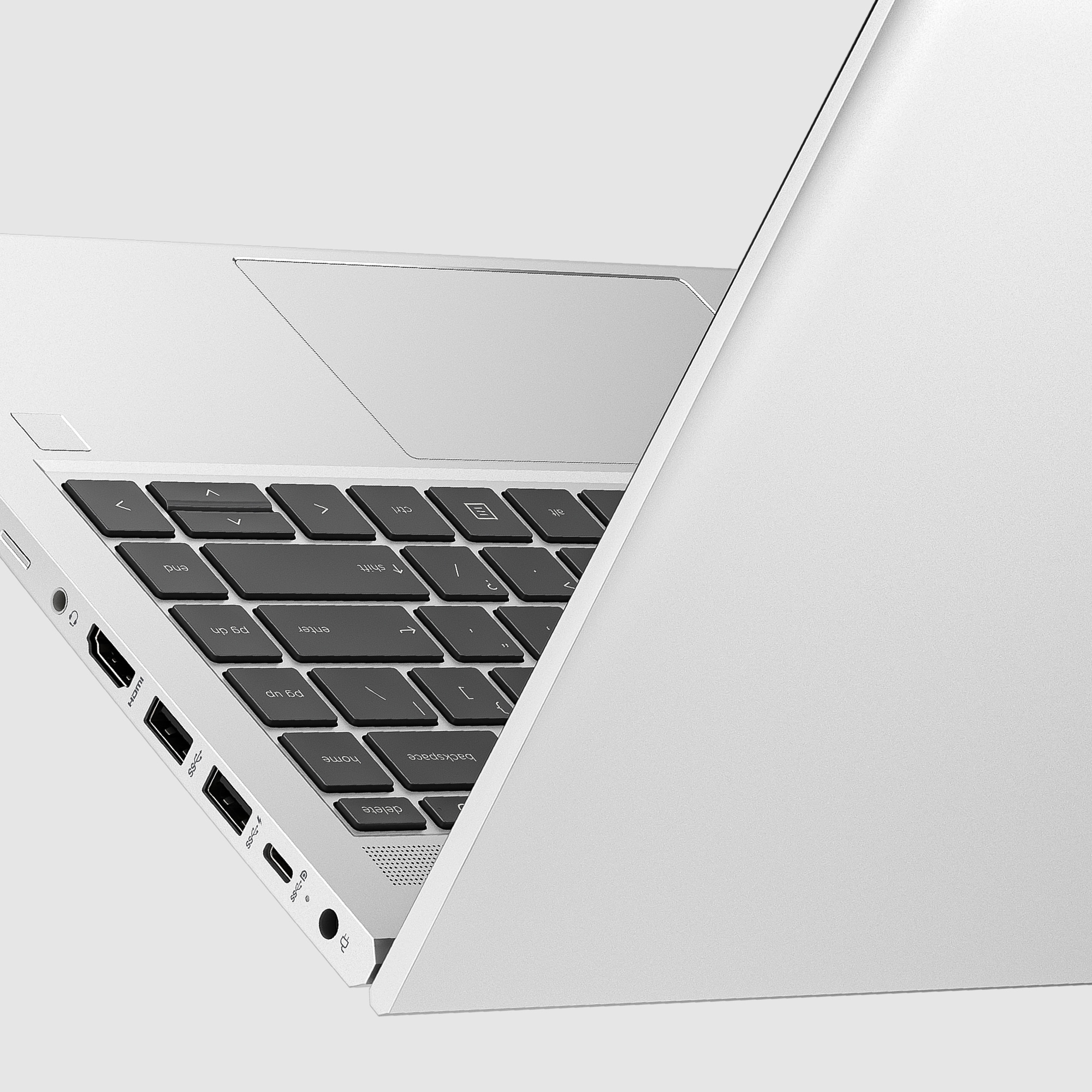 Primo piano della tastiera del laptop con coperchio aperto. Tasti neri, cornice argentata, porte visibili.
