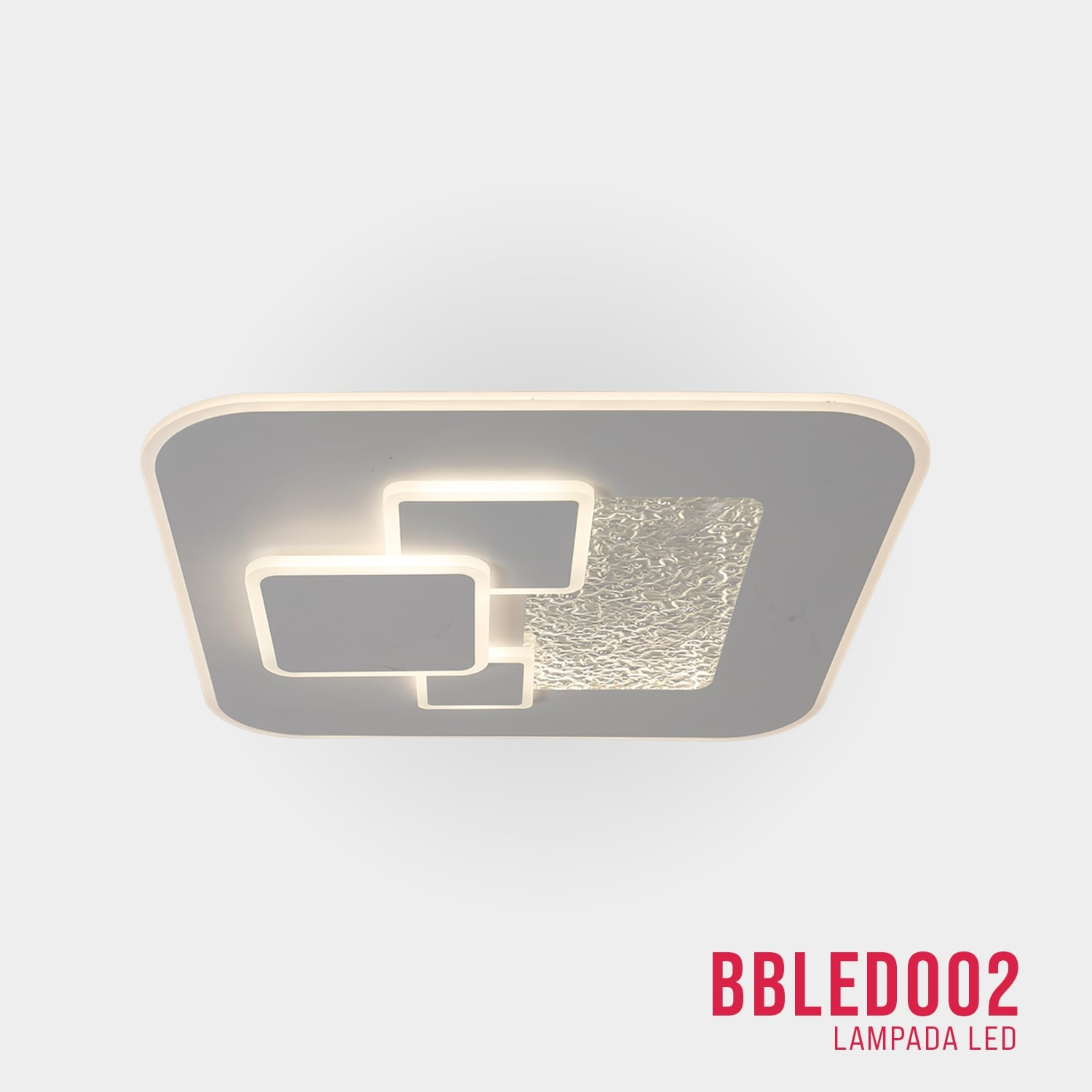 Lampada da soffitto quadrata, cornice grigia, elementi luminosi bianchi e strutturati, su superficie bianca.