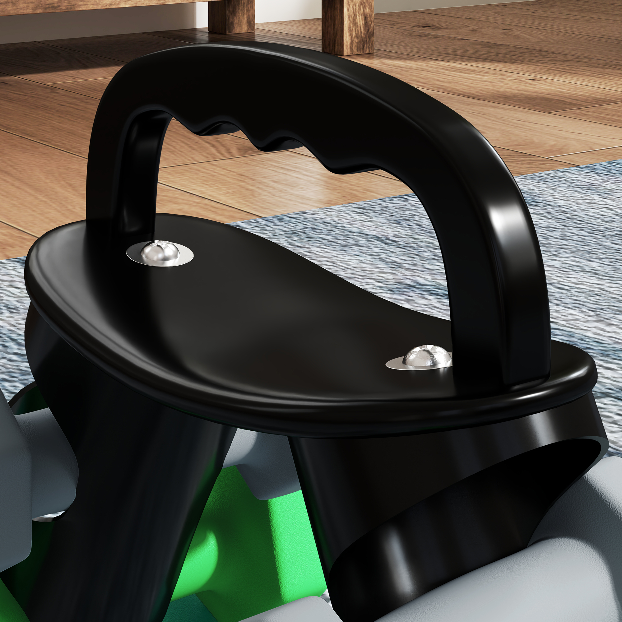 Primer plano de un mango negro con base de metal plateado. El mango está unido a un objeto verde.