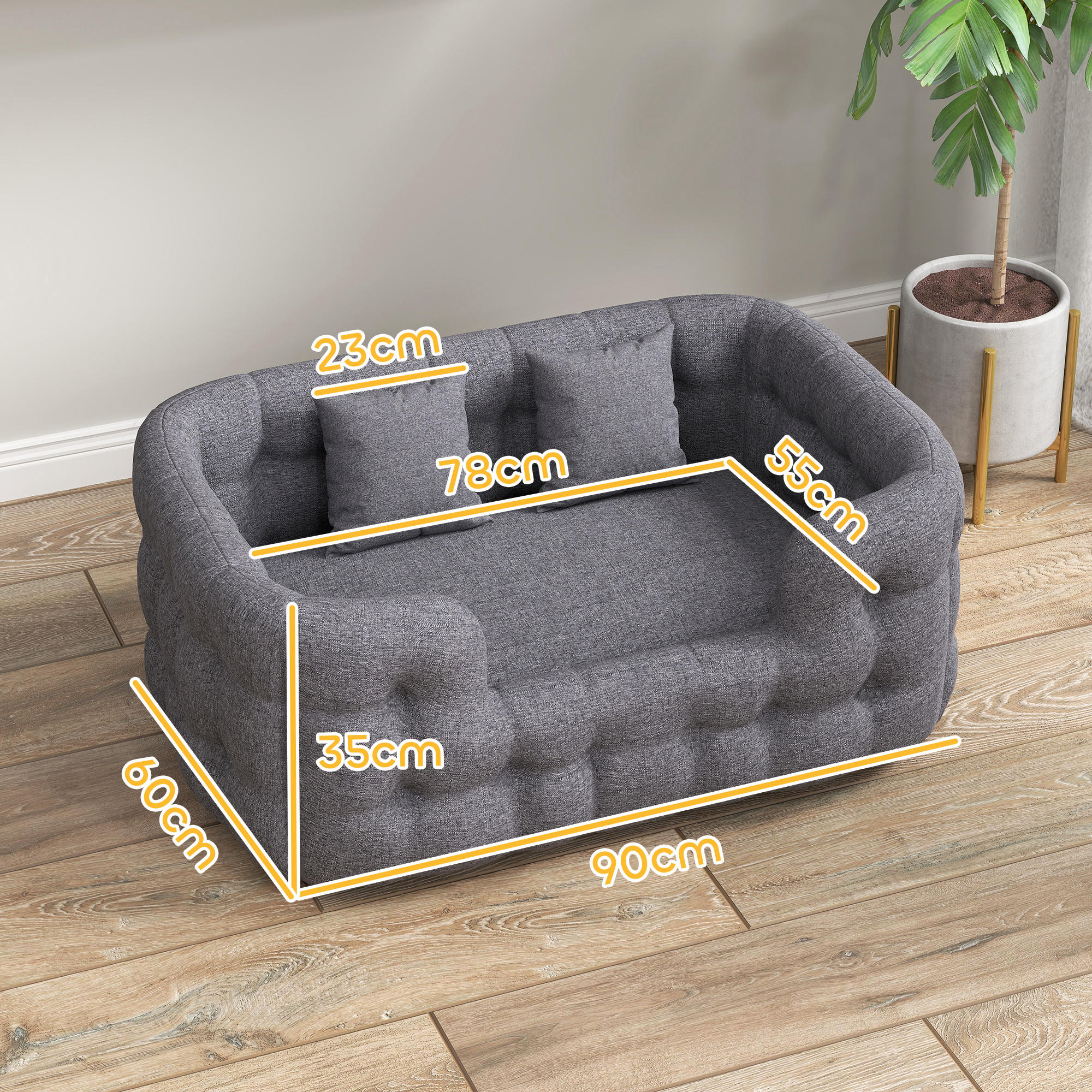 Sofá gris para mascotas con dos almohadas. Se muestran las medidas, con las dimensiones.