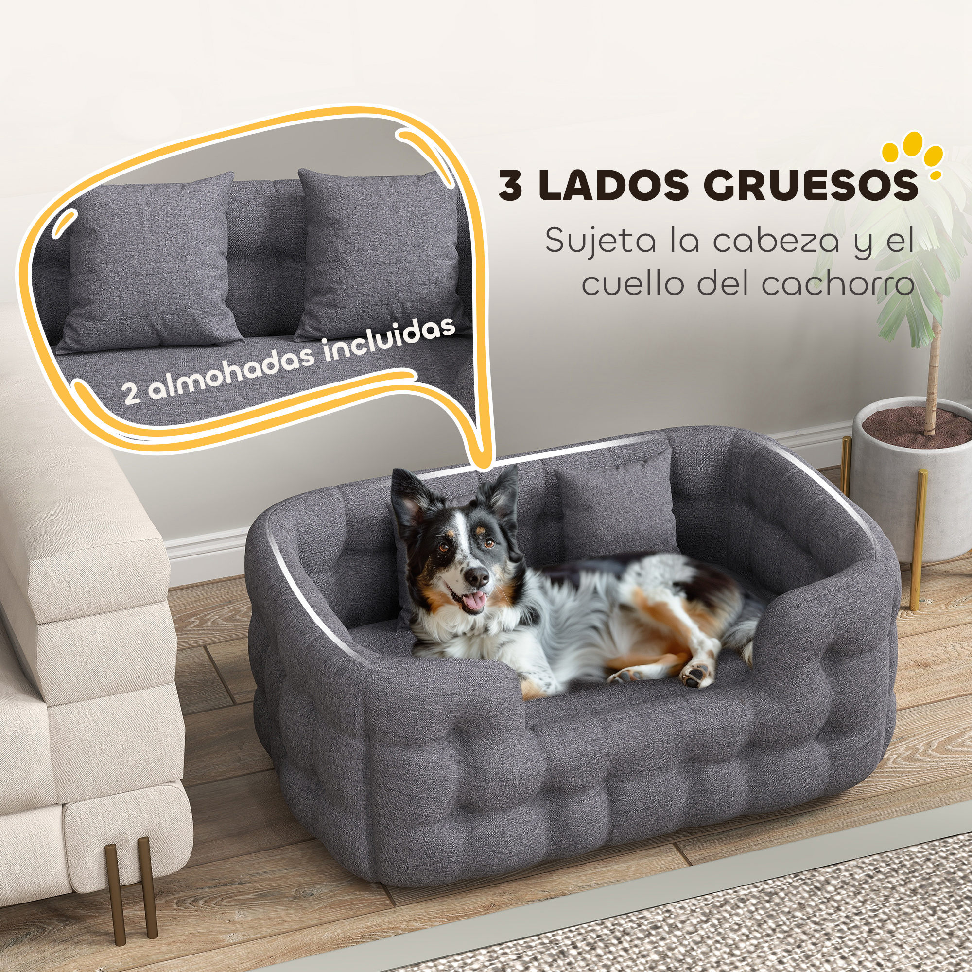 Una cama gris para perros con un perro dentro. Incluye dos almohadas grises. La cama tiene forma redondeada.
