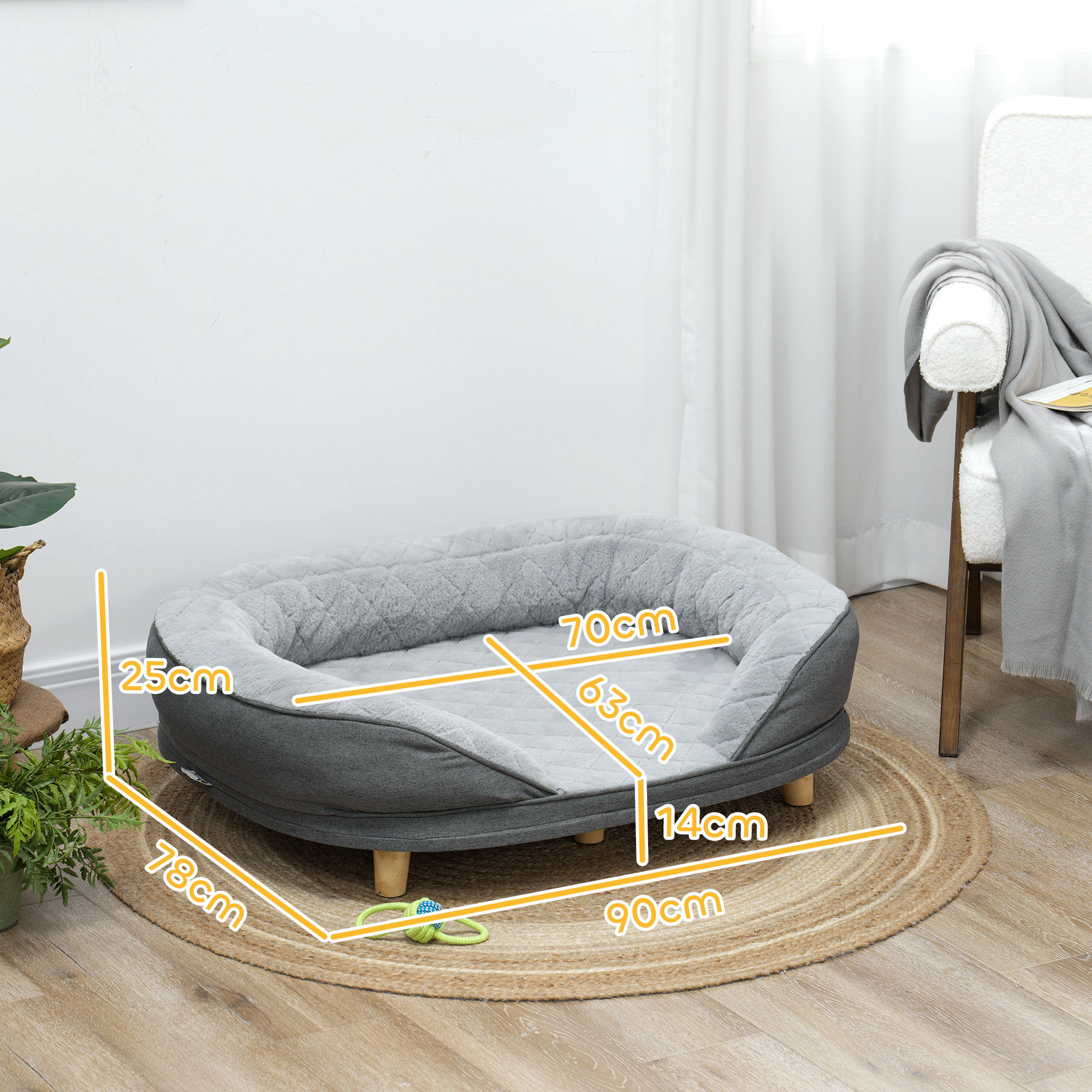 Una cama para perros con dimensiones mostradas. Es gris con una alfombra circular debajo.