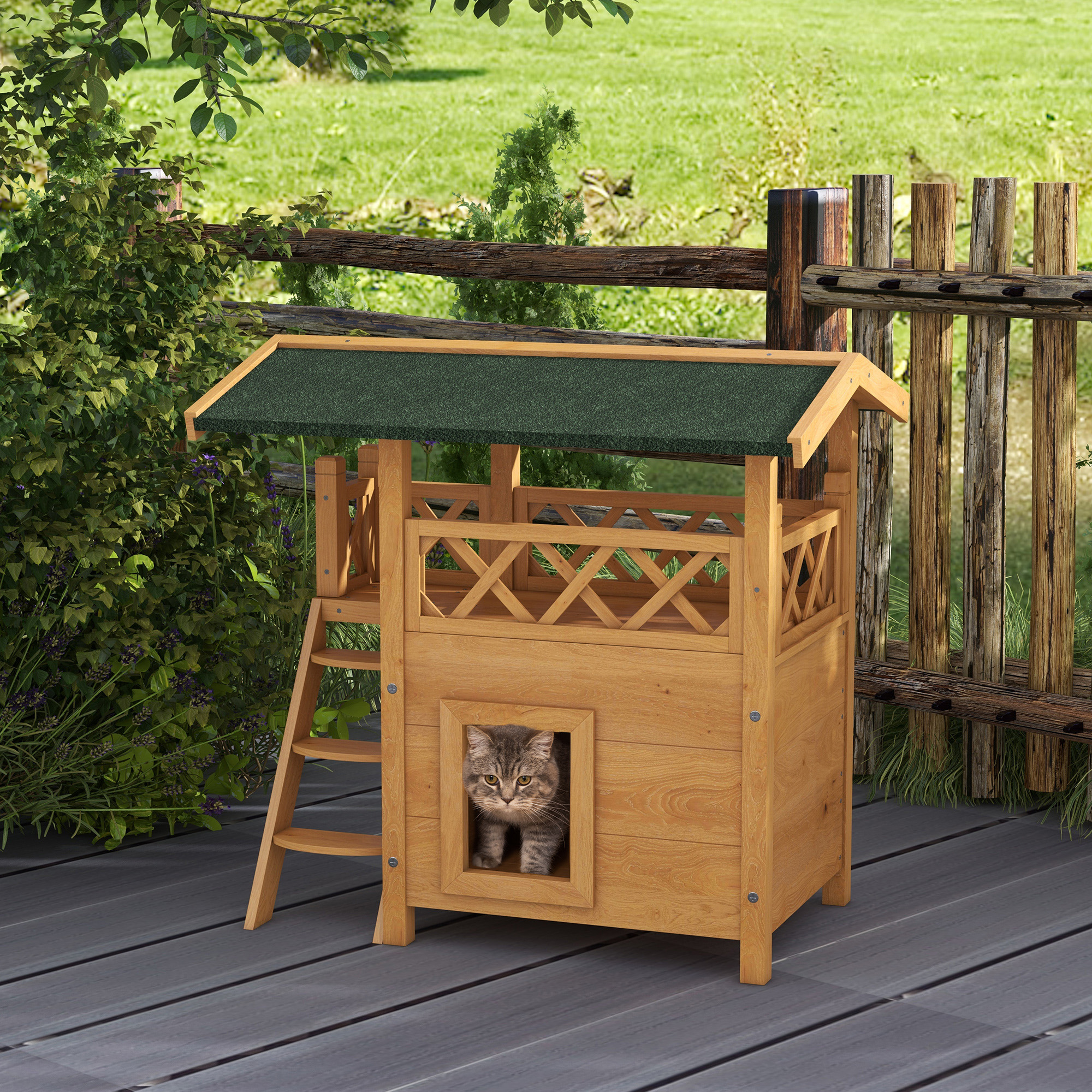 Una casa de madera para gatos con una escalera, una ventana y un techo verde. Un gato está mirando por la ventana.