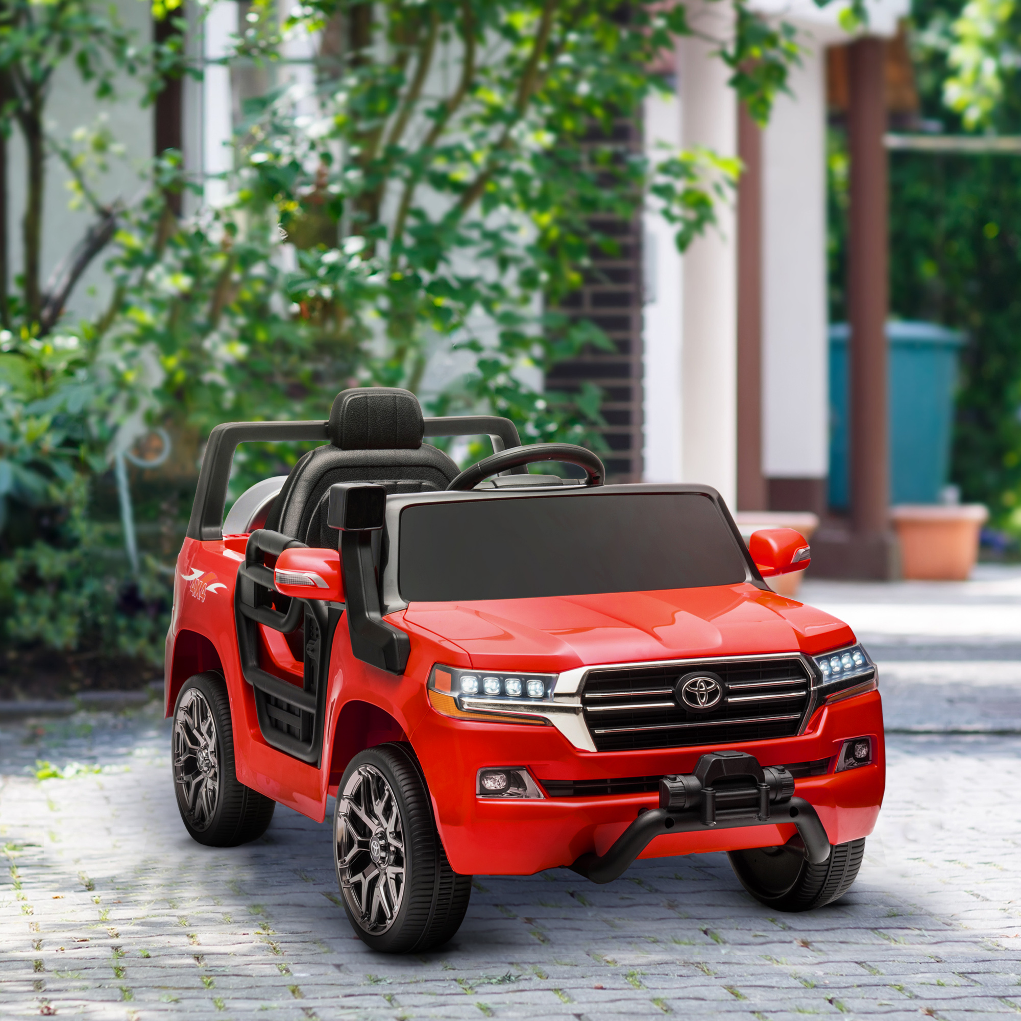 Coche de juguete rojo, parecido a un Toyota Land Cruiser, estacionado sobre una superficie de ladrillo, al aire libre.