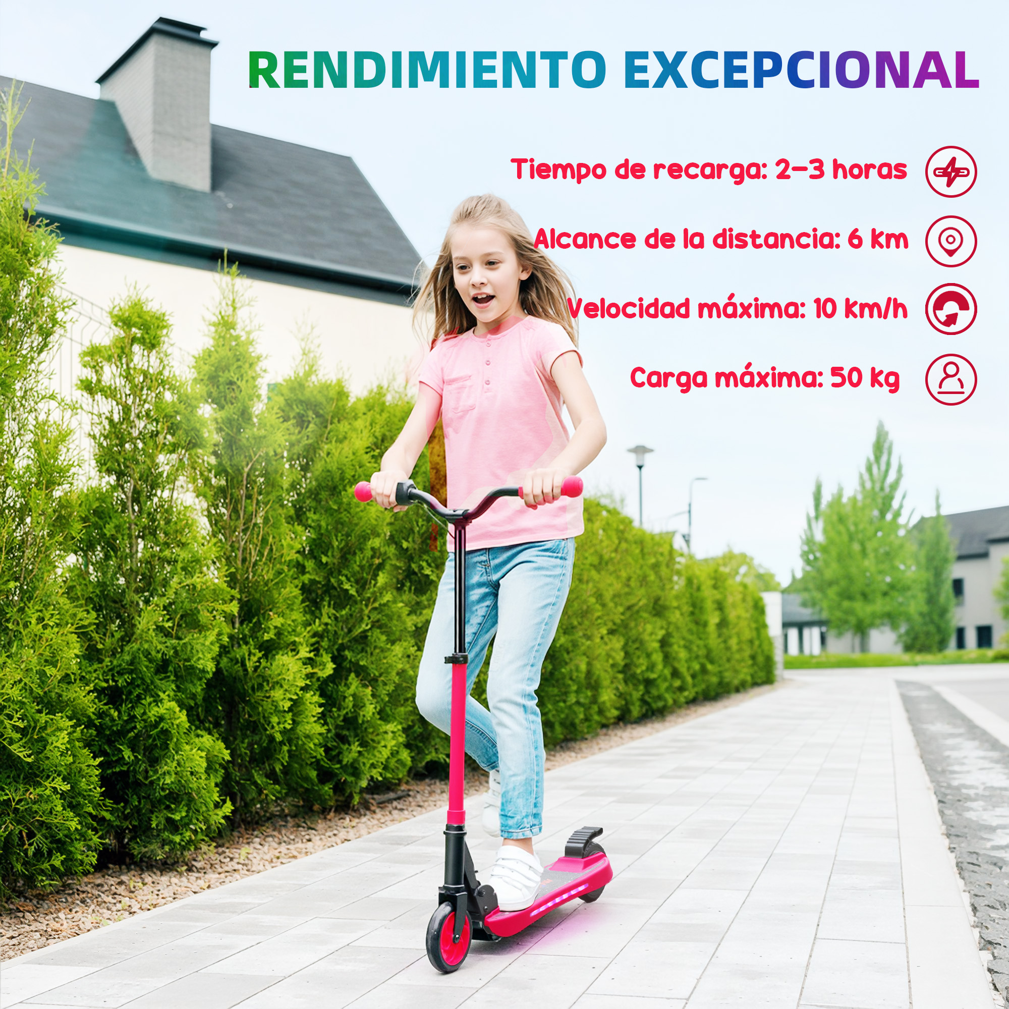 Una niña monta en un patinete rojo por un camino pavimentado con arbustos verdes y casas al fondo.
