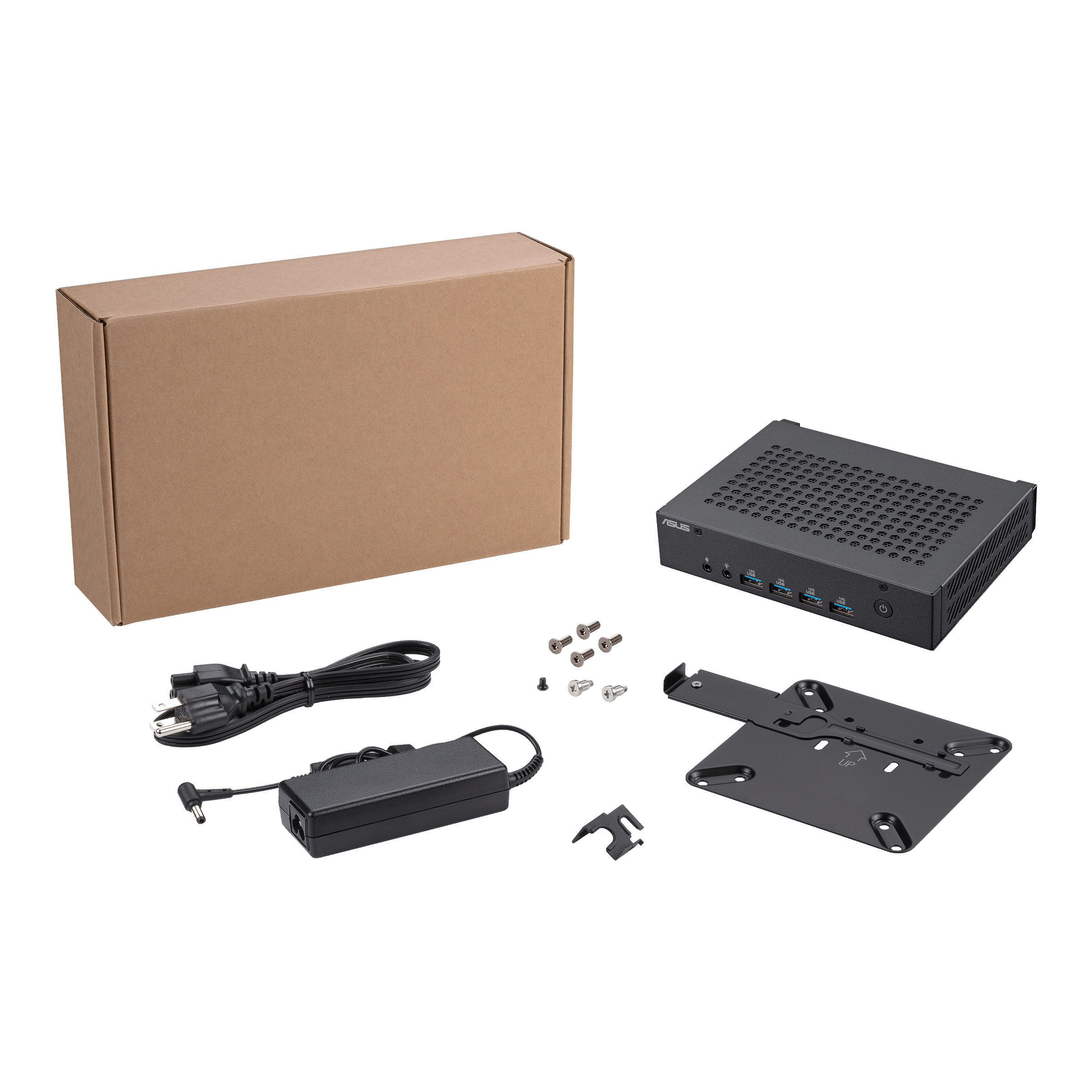 Czarny komputer ASUS z dołączonymi akcesoriami. Widoczny karton, zasilacz i wspornik montażowy.